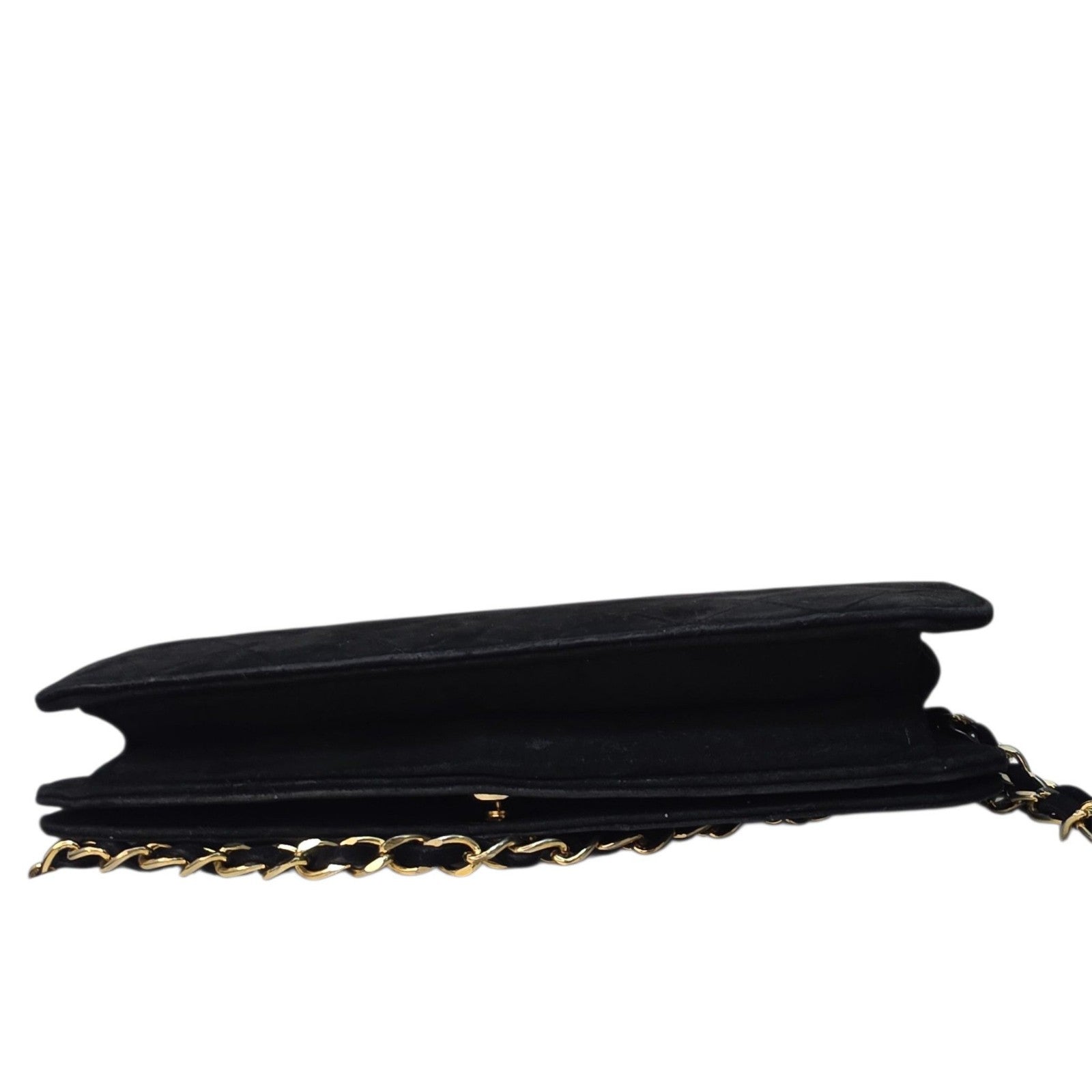 Chanel black quilted suede crossbody bag with gold chain and leather woven strap.