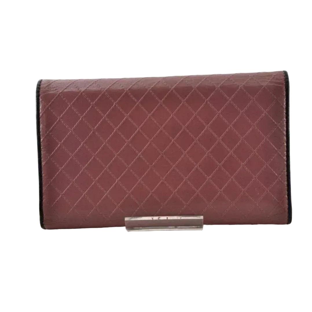 Chanel bifold wallet bordeaux leather with embossed logo and sleek design.