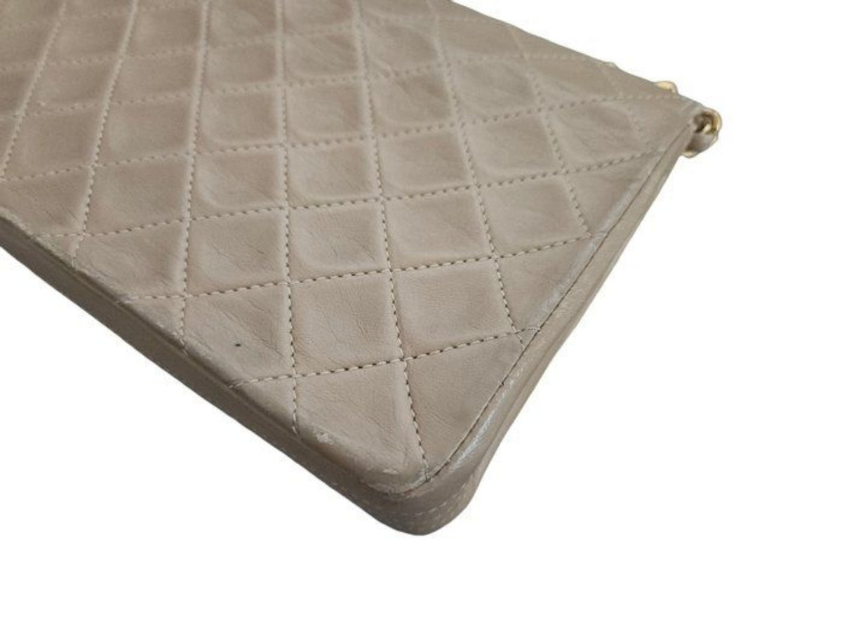 Chanel beige quilted leather flap bag with gold hardware and interlocking CC turn-lock.
