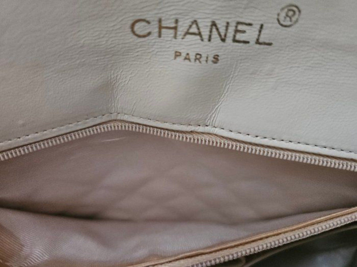 Chanel beige quilted leather flap bag with gold hardware and interlocking CC turn-lock closure.