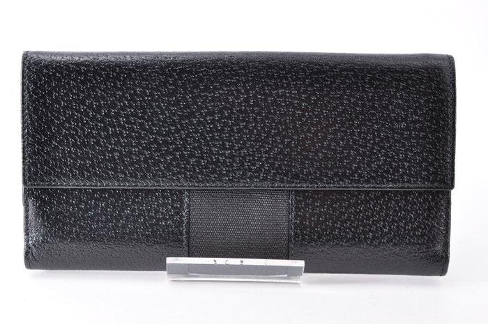 Gucci black leather zip around wallet with gold tone hardware and minimalist design.