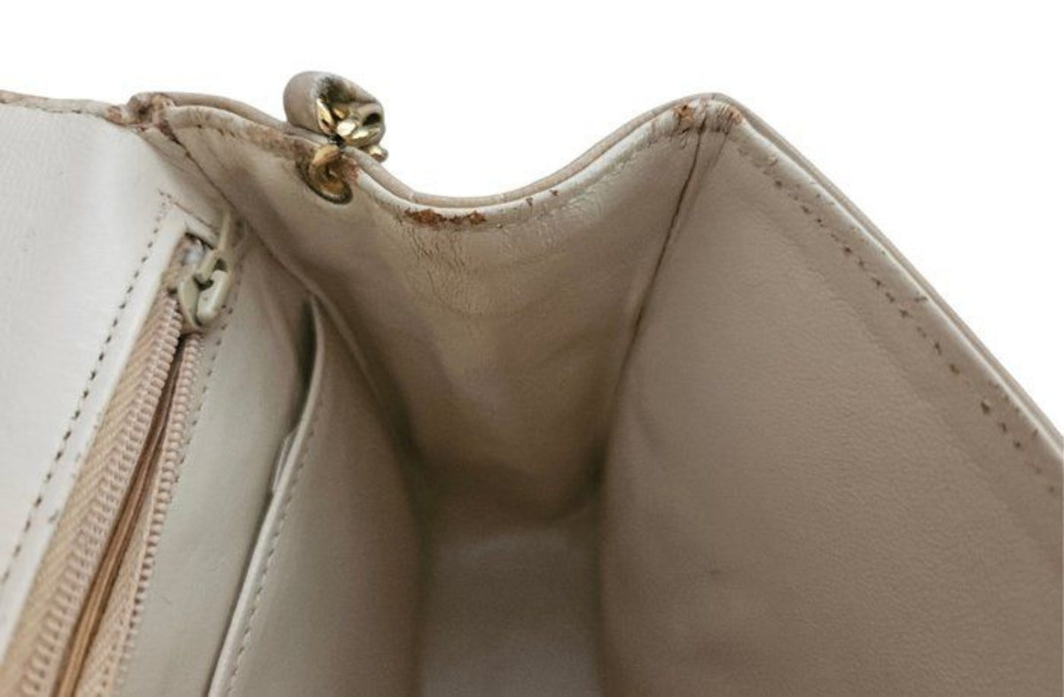 Chanel beige quilted leather flap bag with gold hardware and interlocking CC turn-lock.