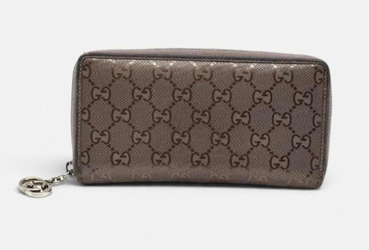 Gucci brown bifold wallet in smooth leather with silver hardware and logo detail.