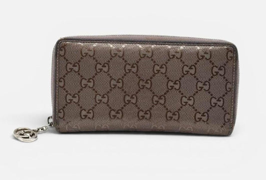 Gucci brown bifold wallet in smooth leather with silver hardware and logo detail.
