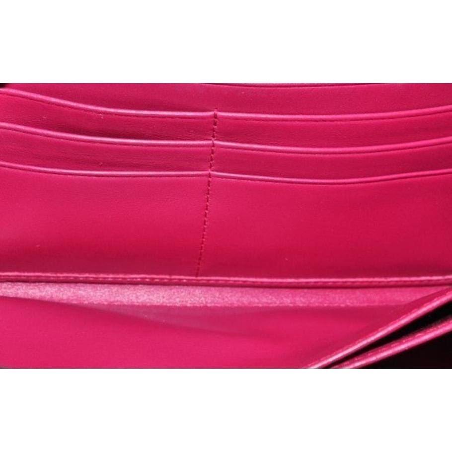 Prada pink nylon and leather zip-around wallet with minimalist design and secure closure.