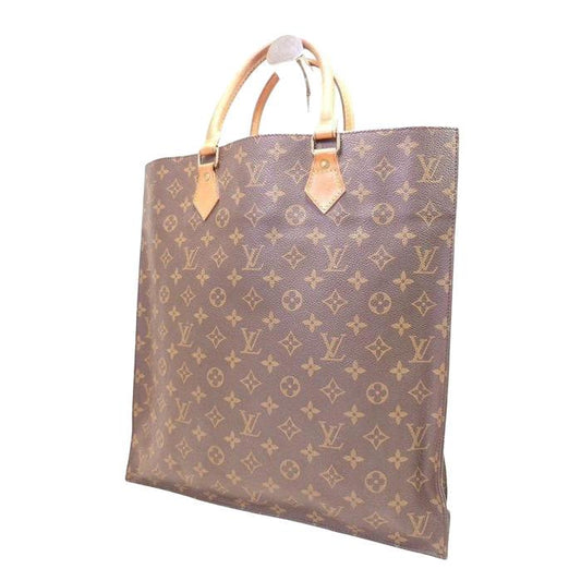 Louis Vuitton gold tote bag vintage monogram canvas with leather handles.