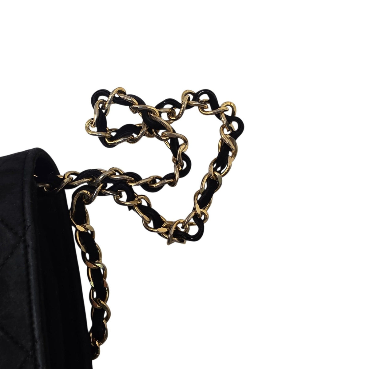 Chanel black quilted suede crossbody bag with gold chain and leather woven strap.