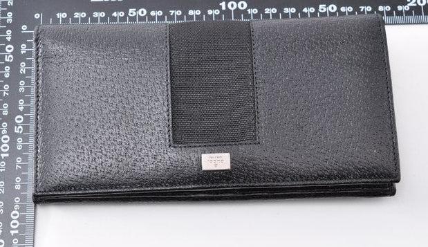 Gucci black leather zip around wallet with gold tone hardware and minimalist design.