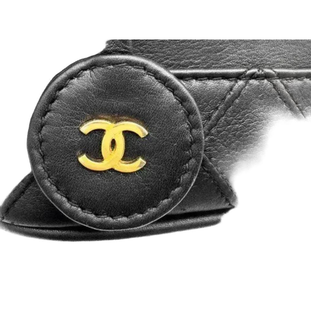 Chanel black bicolore vanity case with gold-tone hardware and iconic stitching details.