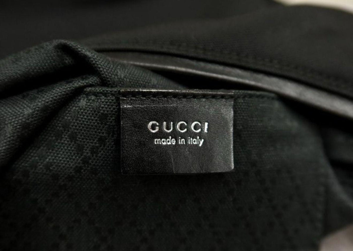 Gucci black nylon and leather shoulder bag with silver accents and logo detail.