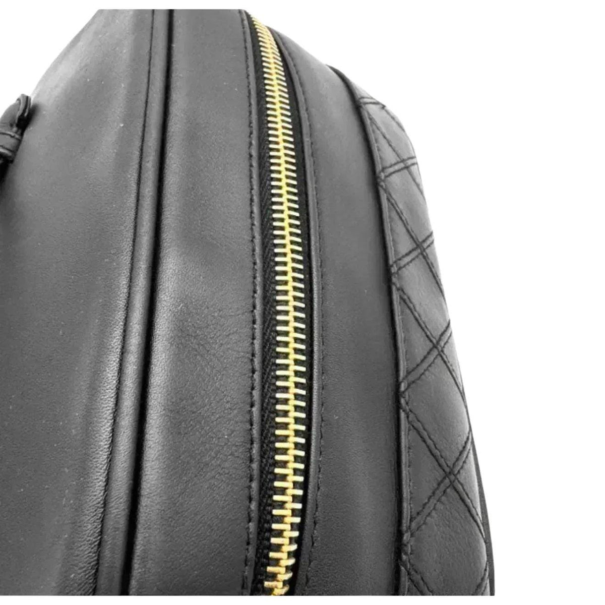 Chanel black bicolore vanity case with gold-tone hardware and iconic stitching details.