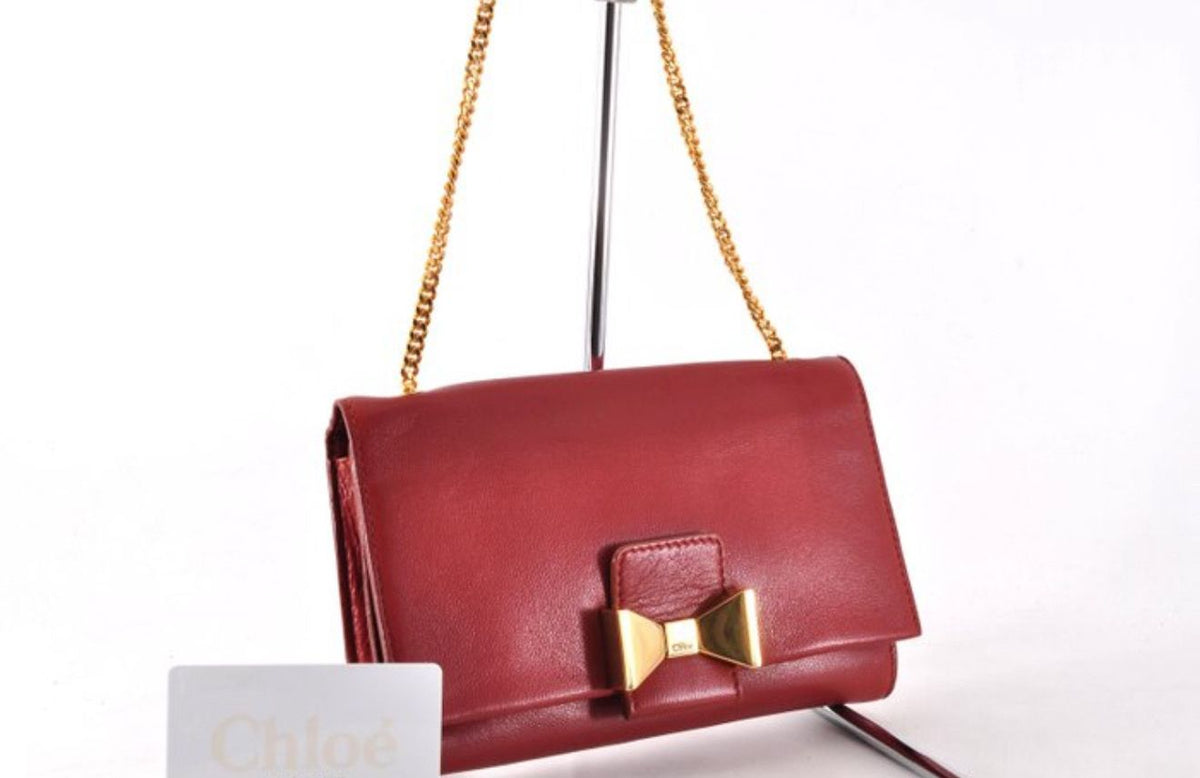 Chloè red wallet on chain smooth leather with gold-tone hardware and compact design.