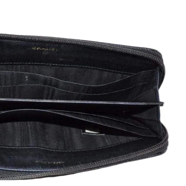 Chanel black zip around wallet in buttery leather with logo and zipper details.