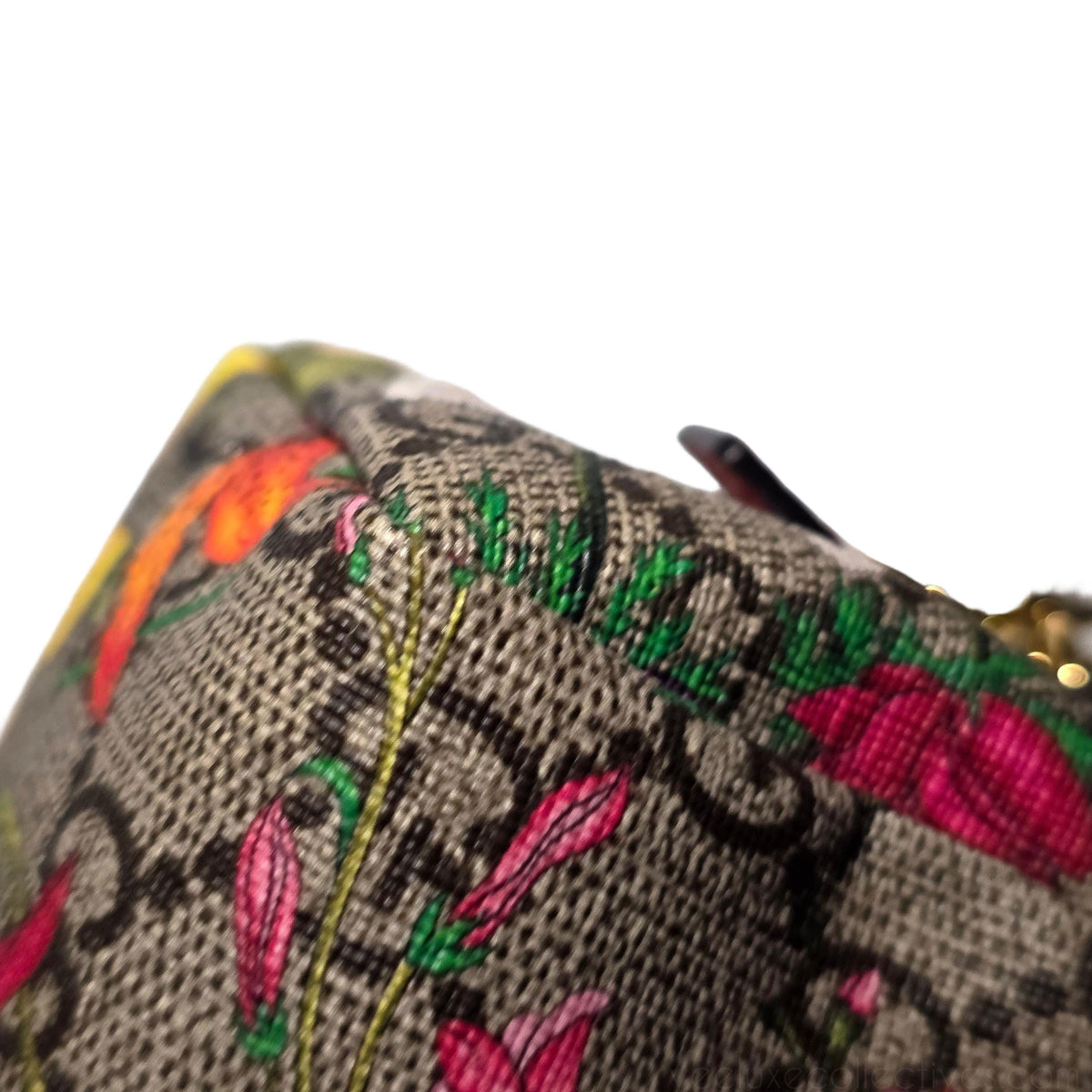 Gucci cream cosmetic case with floral pattern, GG Supreme canvas, and gold hardware.