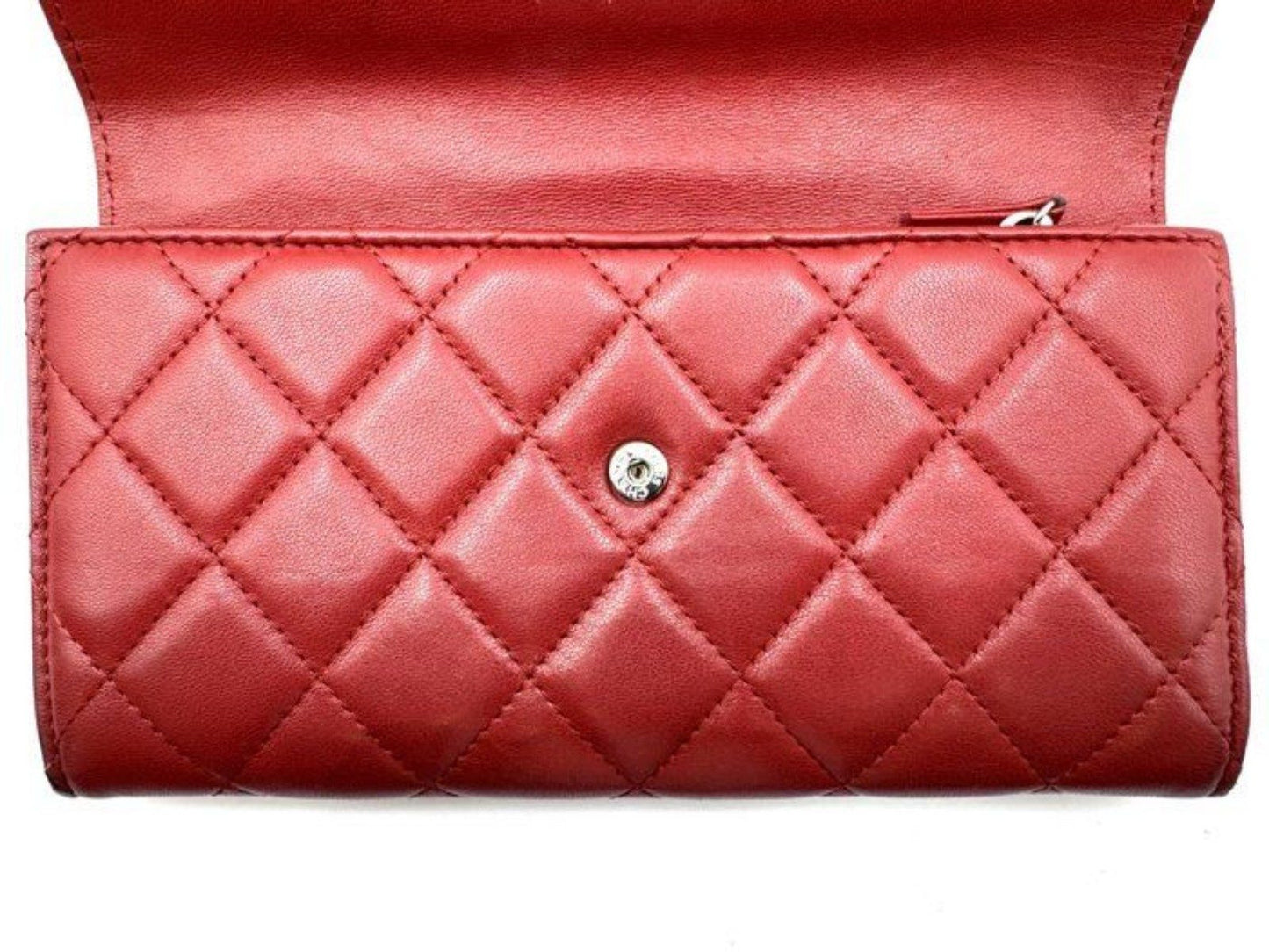 Chanel red quilted leather wallet with CC logo and fabric-lined interior.