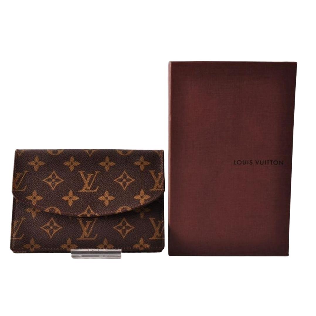 Louis Vuitton brown card case with monogram canvas and smooth leather trim.