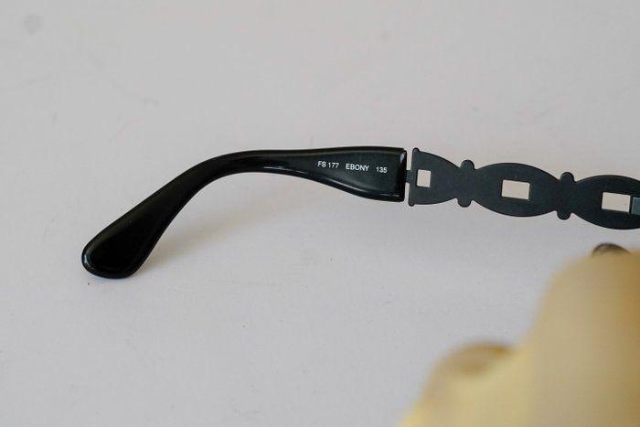 Fendi black and gold sunglasses with logo detail, high-quality plastic and metal frame.