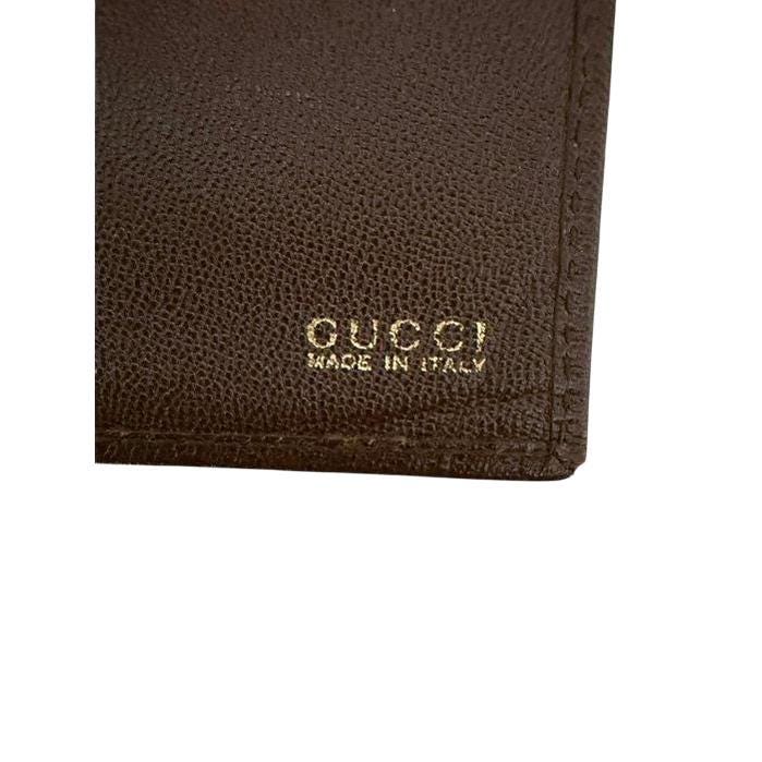 Gucci brown bifold wallet smooth leather with iconic logo and vintage craftsmanship.
