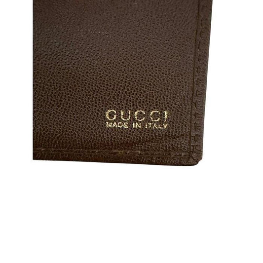 Gucci brown bifold wallet smooth leather with iconic logo and vintage craftsmanship.