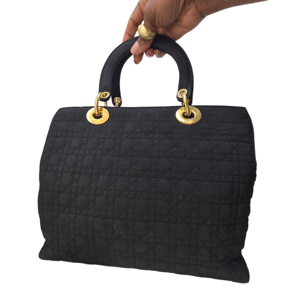 Christian Dior black quilted nylon tote bag with gold hardware and leather trim.