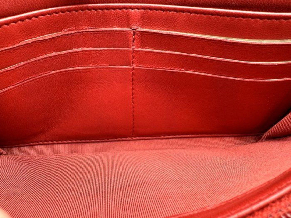 Chanel red quilted leather wallet with CC logo and fabric-lined interior.