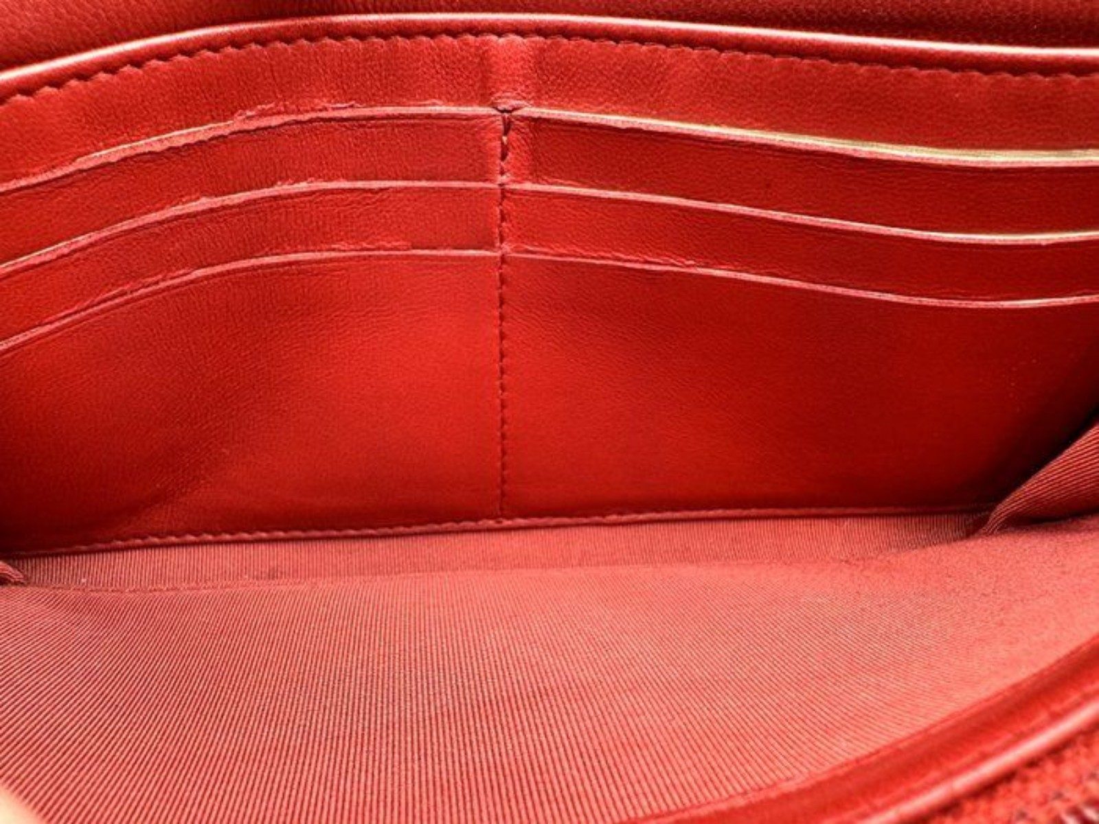 Chanel red quilted leather wallet with CC logo and fabric-lined interior.