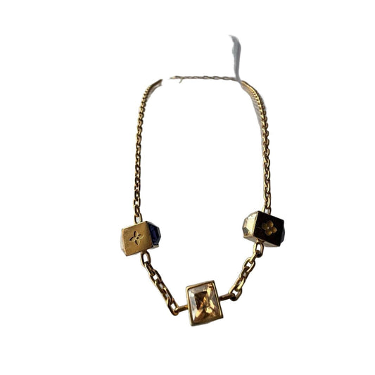 Louis Vuitton gold necklace with monogram dice charms and sparkling crystals.