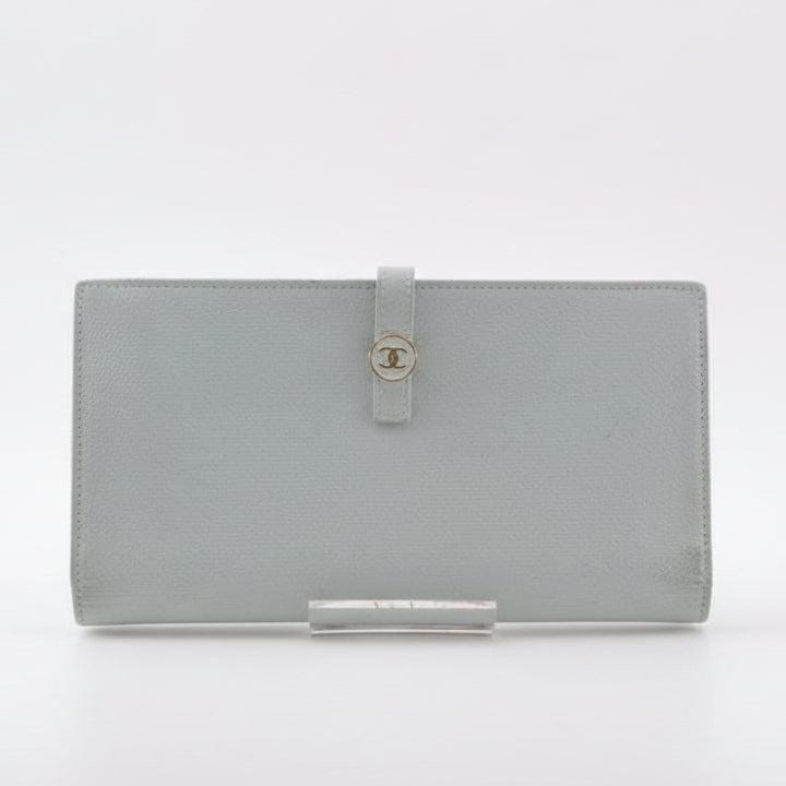 Chanel blue leather wallet with logo detail and minimalist design, featuring light scuffs.