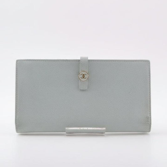 Chanel blue leather wallet with logo detail and minimalist design, featuring light scuffs.