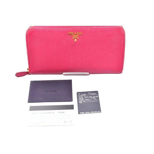 Prada pink leather zip-around wallet with authenticity card and metal zipper detail.
