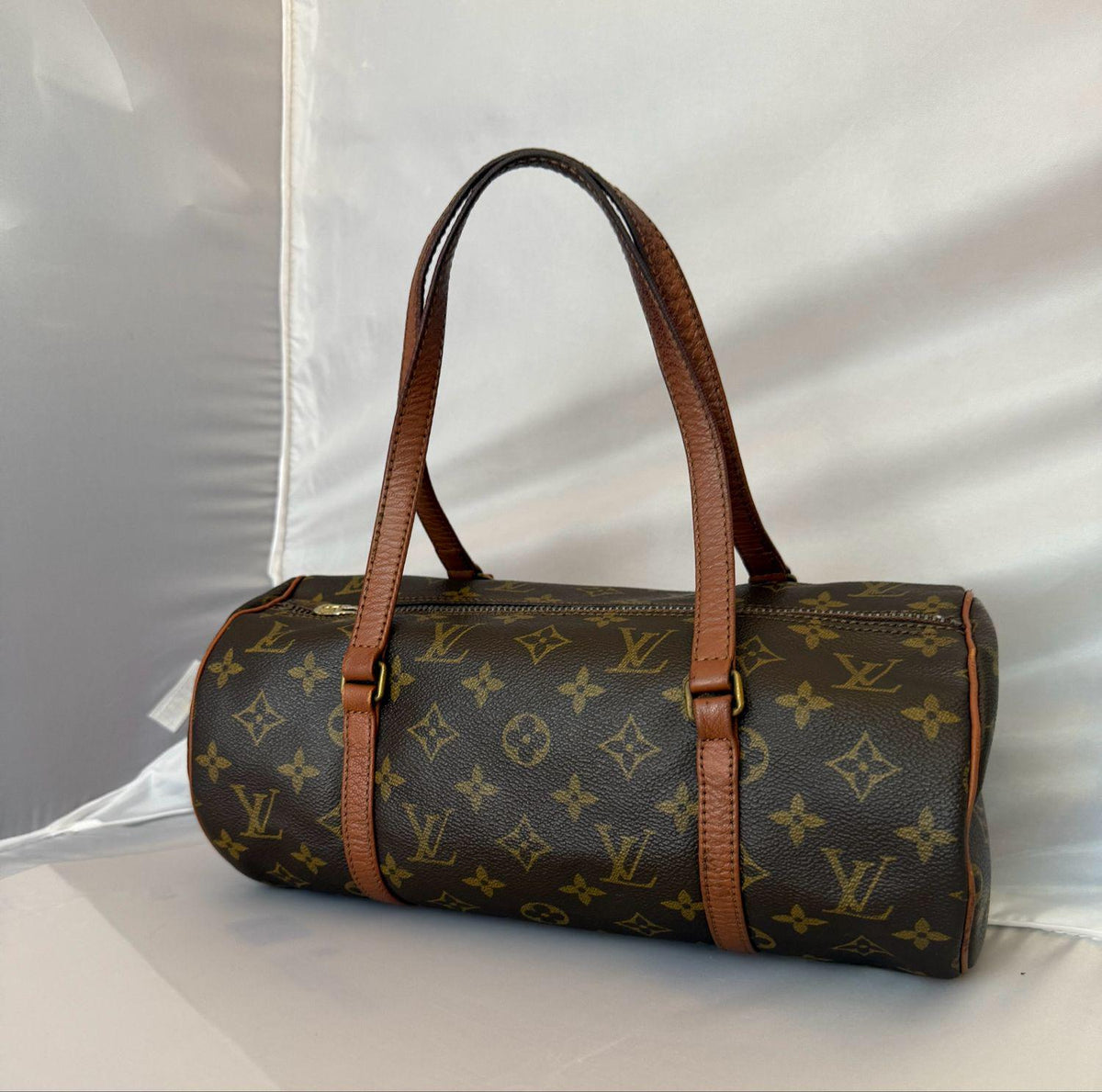 Louis Vuitton brown barrel bag monogram canvas with smooth cowhide trim and brass hardware.