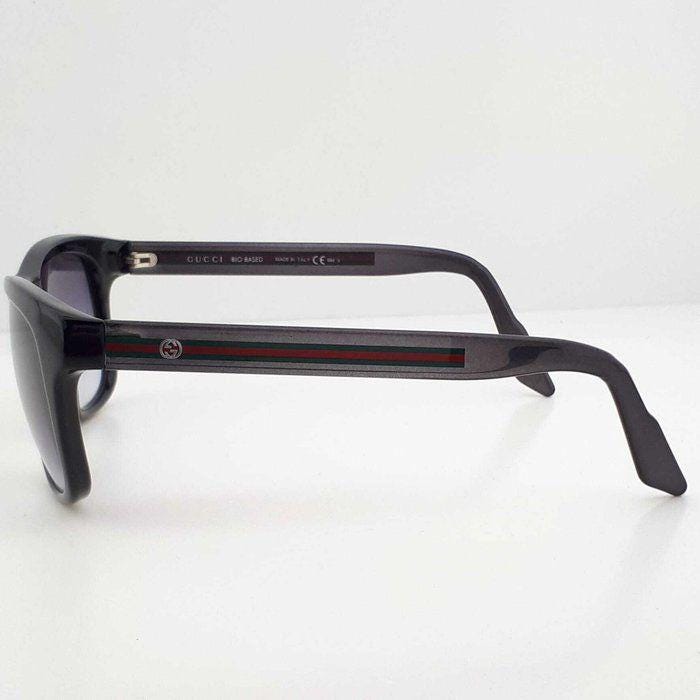Gucci black Wayfarer sunglasses with grey gradient lenses and red-green striped temples.