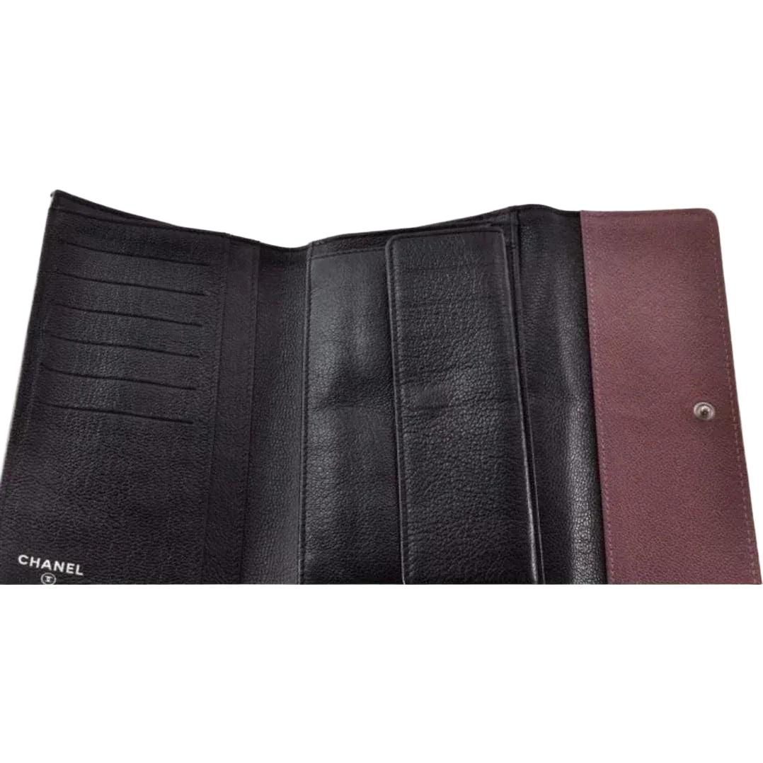 Chanel bifold wallet bordeaux leather with embossed logo and sleek design.