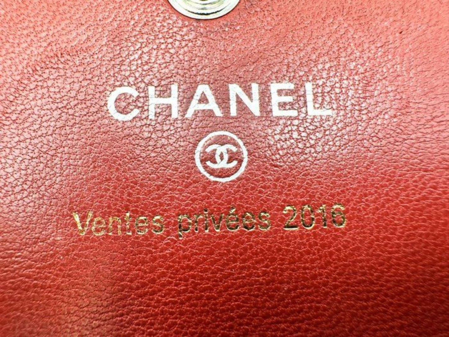 Chanel red quilted leather wallet with CC logo and fabric-lined interior.