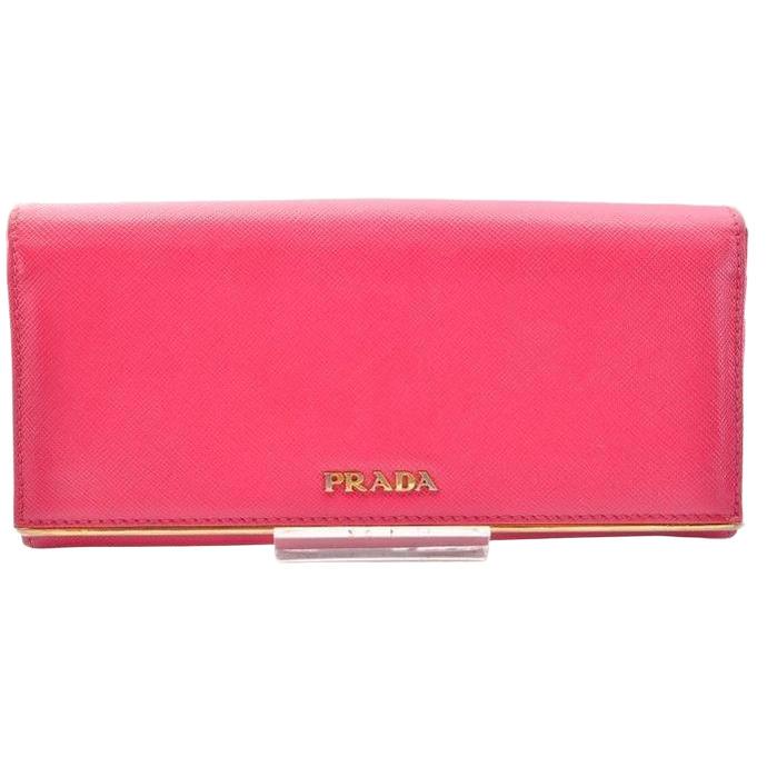 Prada pink leather wallet with logo detail and slim design, perfect for essentials.