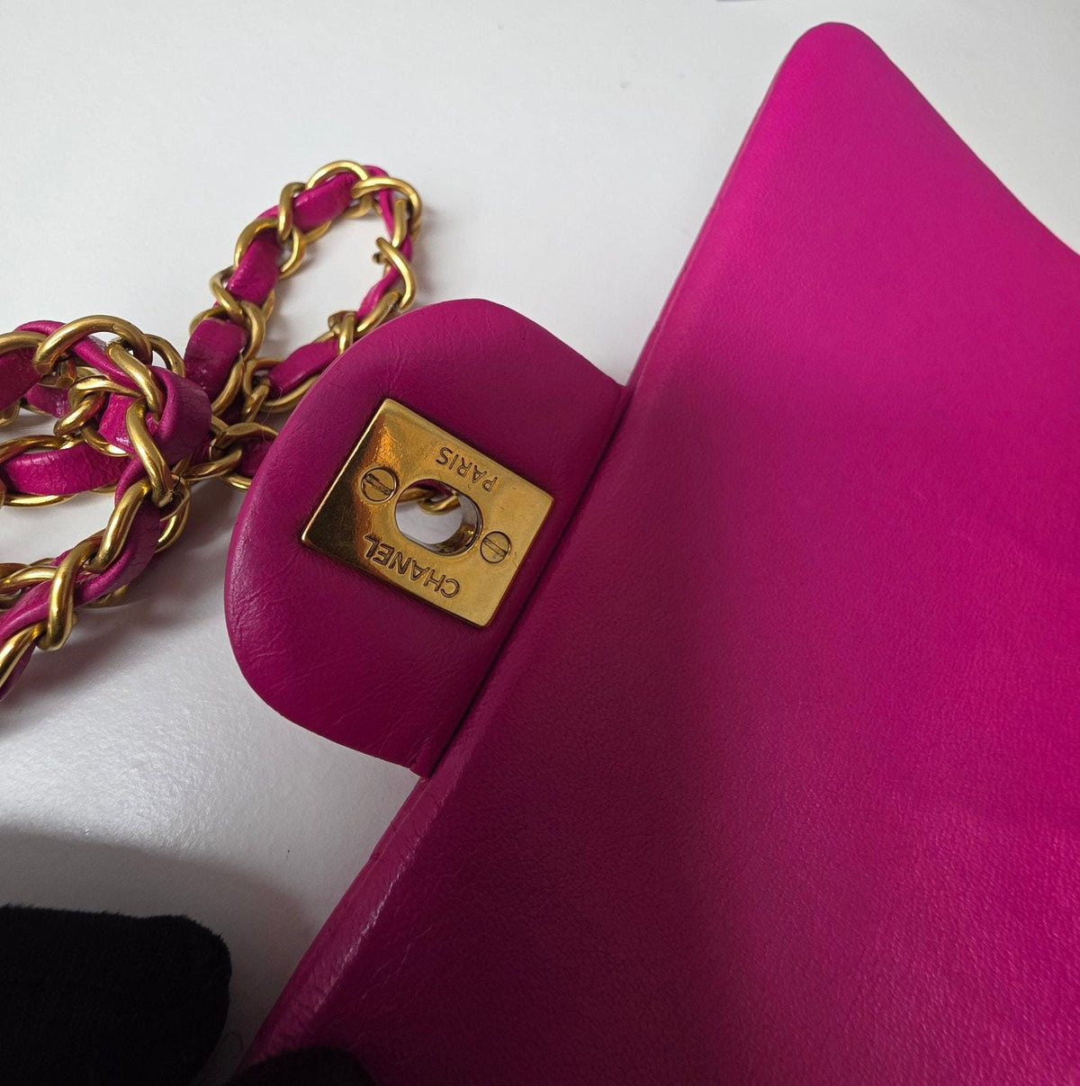 Chanel pink mini messenger bag in chevron leather with gold CC clasp and hardware.