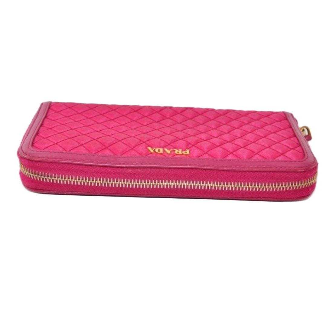 Prada pink nylon and leather zip-around wallet with minimalist design and secure closure.