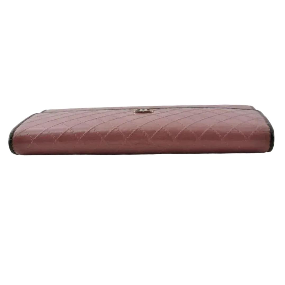 Chanel bifold wallet bordeaux leather with embossed logo and sleek design.