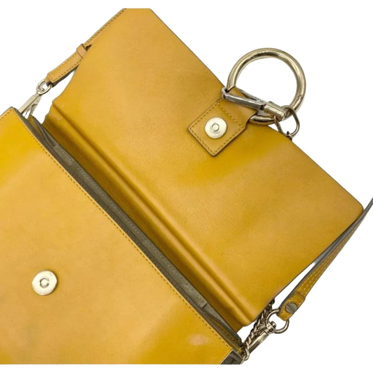 Chloè yellow messenger bag with gold-tone ring, suede and leather textures.
