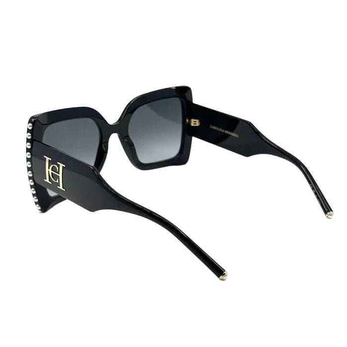 Carolina Herrera black acetate sunglasses with grey lenses and signature logo detailing.