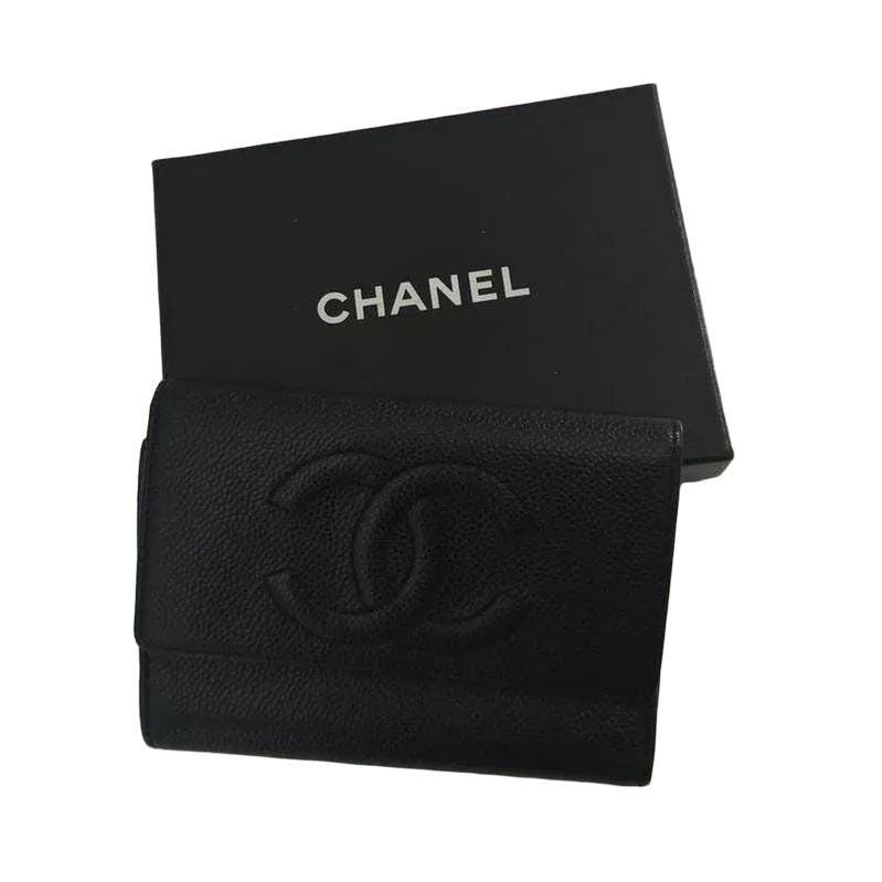 Chanel black caviar leather bifold wallet with gold logo and textured finish.