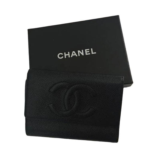 Chanel black caviar leather bifold wallet with gold logo and textured finish.