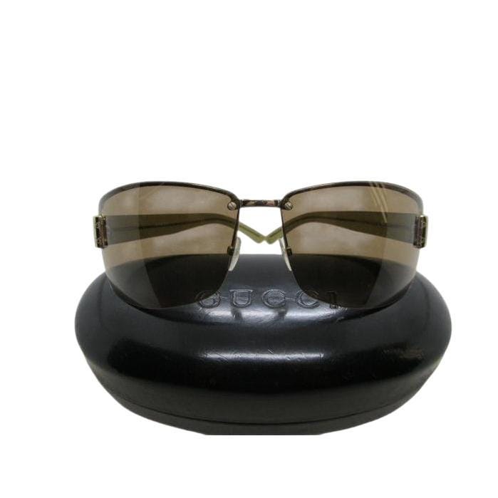 Gucci half-rim wrap sunglasses in green and gold, featuring vintage design and logo.
