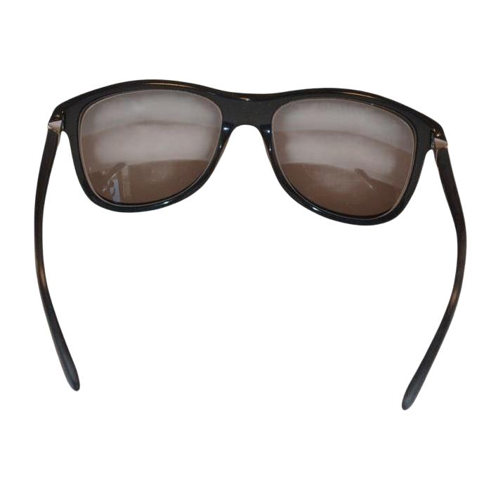 Prada black sunglasses with sleek frames, metal and plastic blend, minimalistic design.