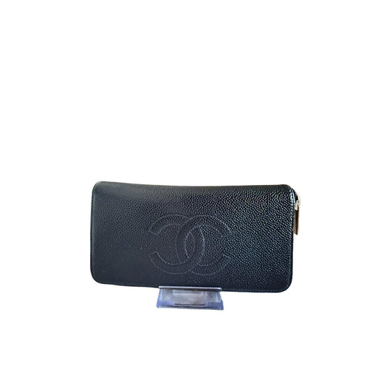 Chanel black zip around wallet in buttery leather with logo and zipper details.