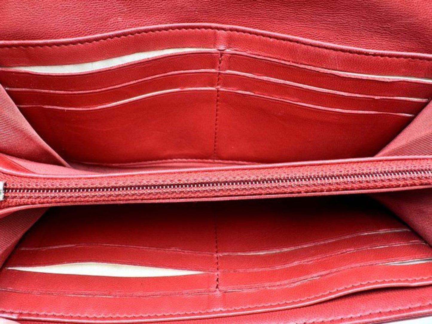 Chanel red quilted leather wallet with CC logo and fabric-lined interior.