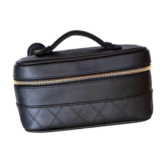 Chanel black bicolore vanity case with gold-tone hardware and iconic stitching details.