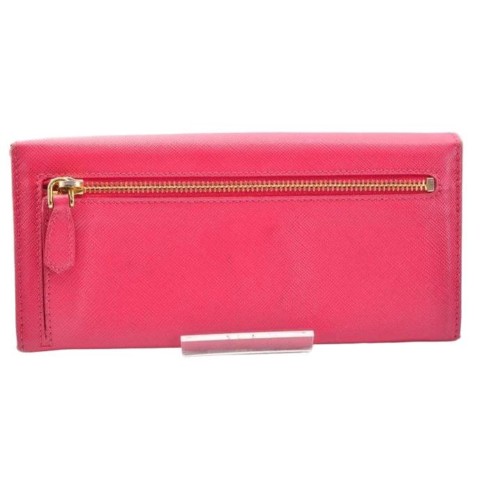 Prada pink leather wallet with logo detail and slim design, perfect for essentials.
