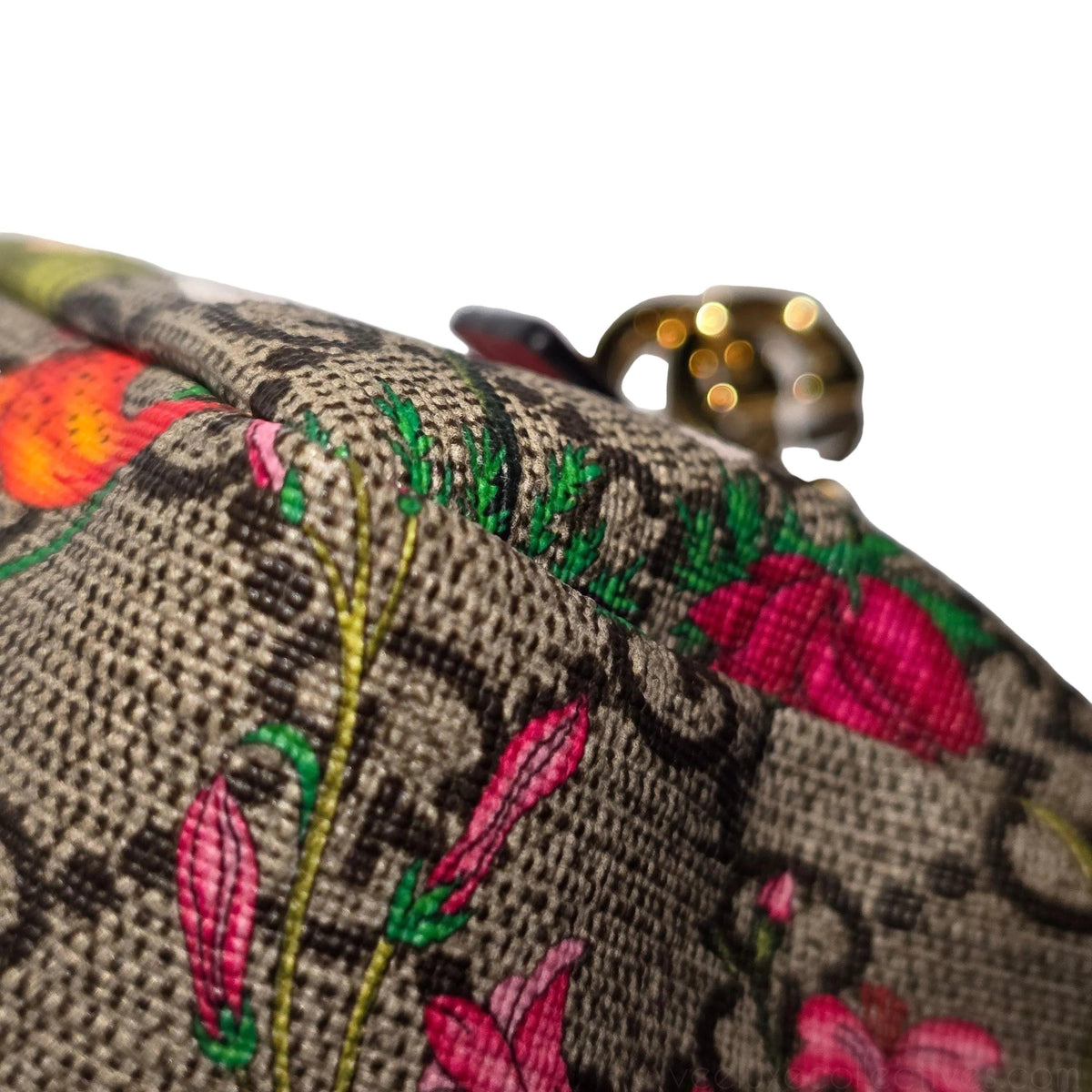 Gucci cream cosmetic case with floral pattern, GG Supreme canvas, and gold hardware.