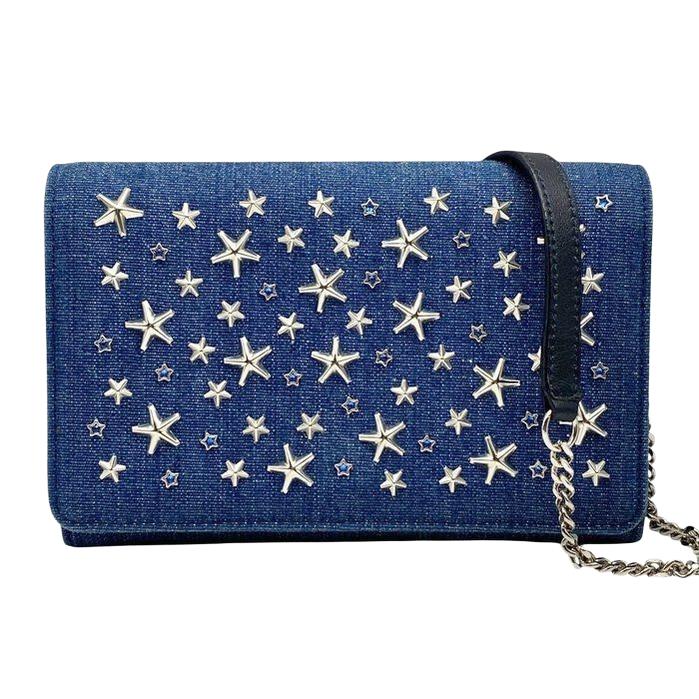 Jimmy Choo blue denim crossbody bag with silver star studs and chain-link strap.